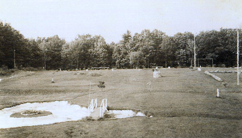 early photo of golf course with sand trap in foreground