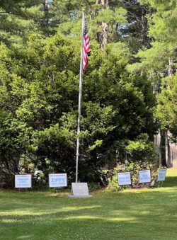 Memorial flag with sponsorship signs surrounding