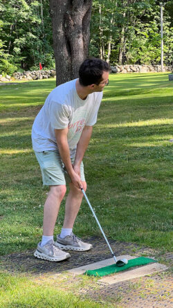Player takes his stance at the tee lining up a shot