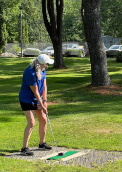 Partners Bank team member readies a tee shot