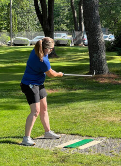player from Partners Bank team follows through tee shot