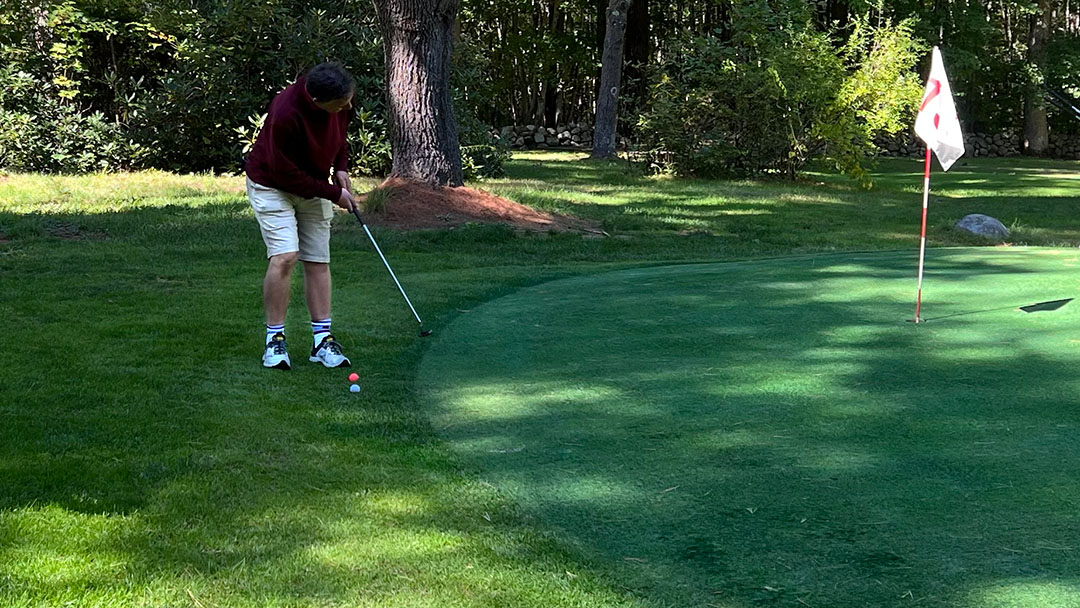 Chamber of Commerce player chips a shot onto the green