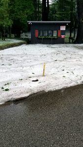 Hail covered putting green at golf course entrance