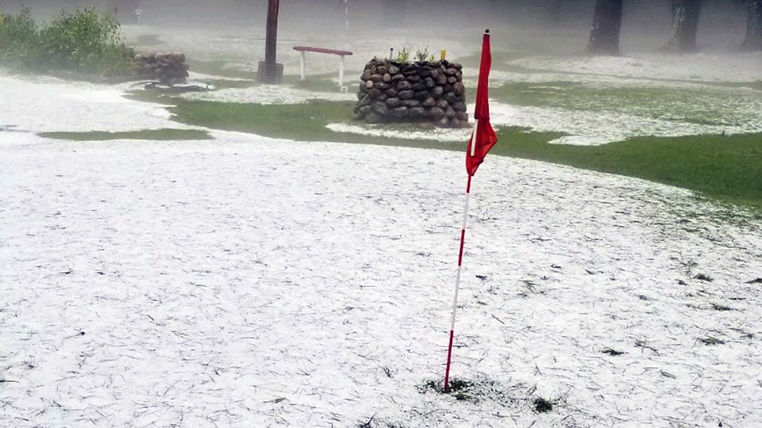 hail and mist at hole on golf course