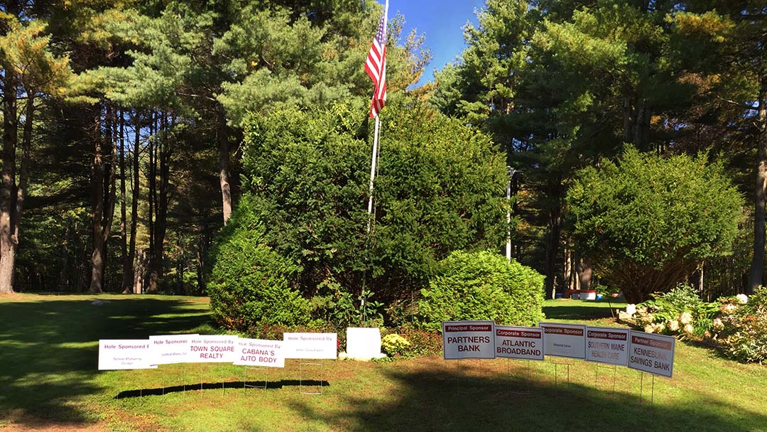 Business Sponsor Signs Below the Flag at Hole 1