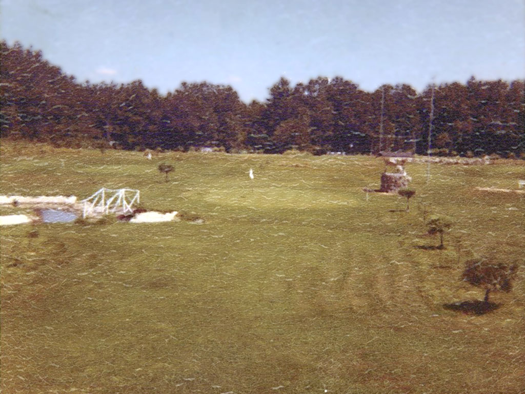 Early photo of golf course with trees just starting to grow