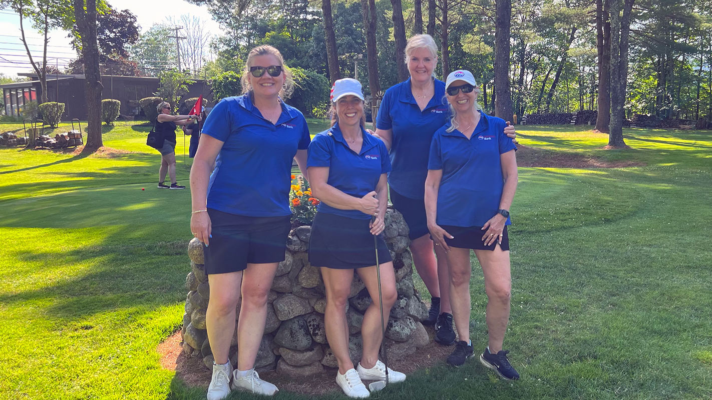 Partners Bank team in matching royal blue shirts pose for a team photo