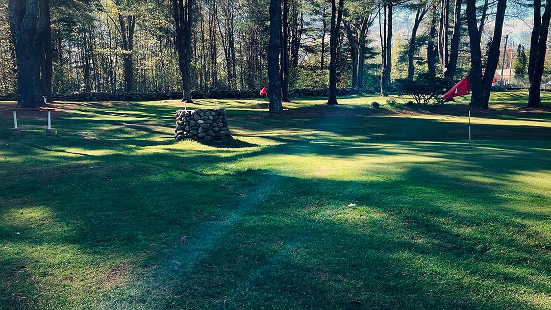 Sun rays on shady, sun-dappled golf course