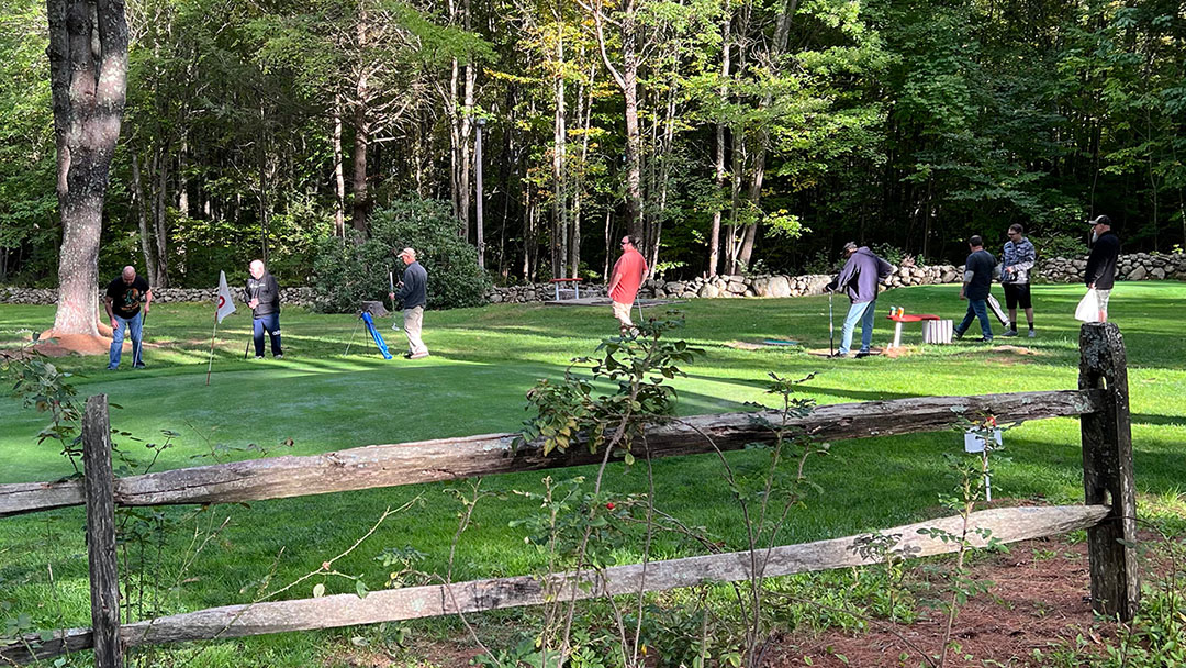 two teams playing different holes on golf course